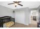 Neutral-toned bedroom featuring a crib and double-door closet, providing a serene and practical space at 7710 Eagle Crescent Dr, Zionsville, IN 46077