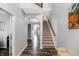 Elegant foyer with hardwood flooring, staircase, and an arched doorway, creating a grand entrance at 7710 Eagle Crescent Dr, Zionsville, IN 46077