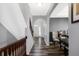 Well-lit foyer features hardwood floors, a wooden banister, and a clear view of the home's front entrance at 7710 Eagle Crescent Dr, Zionsville, IN 46077
