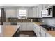 Modern kitchen featuring white cabinets, stainless steel appliances, gray backsplash, and stylish countertops at 7710 Eagle Crescent Dr, Zionsville, IN 46077