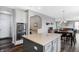 Modern kitchen with stainless steel double ovens and a center island, flowing into the living and dining area at 7710 Eagle Crescent Dr, Zionsville, IN 46077
