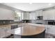 Bright kitchen featuring white cabinets, stainless steel appliances, gray backsplash, and a stylish center island at 7710 Eagle Crescent Dr, Zionsville, IN 46077