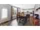 Eat-in kitchen has hardwood floors, stainless appliances, and white cabinets; backyard is visible through the kitchen window at 7710 Eagle Crescent Dr, Zionsville, IN 46077