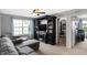 Comfortable living room features a gray couch, TV, and view through a bright window at 7710 Eagle Crescent Dr, Zionsville, IN 46077