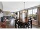 Bright open-plan living and dining area featuring modern decor, dark wood floors, and ample natural light at 7710 Eagle Crescent Dr, Zionsville, IN 46077
