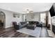 Comfortable living room offers neutral paint, hardwood floors, a ceiling fan, a fireplace, and a large leather couch at 7710 Eagle Crescent Dr, Zionsville, IN 46077