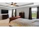 Spacious primary bedroom featuring large windows with views, a ceiling fan, and carpet floors at 7710 Eagle Crescent Dr, Zionsville, IN 46077