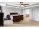 Spacious primary bedroom with tray ceilings, carpet floors, and access to the bathroom at 7710 Eagle Crescent Dr, Zionsville, IN 46077
