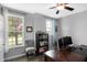 Well-lit office boasts hardwood floors, neutral paint, a chair, and shelving for storing books and decorations at 7710 Eagle Crescent Dr, Zionsville, IN 46077