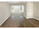 Spacious basement with windows and a door on laminated wood and carpet flooring, offering flexible space for various uses at 825 Treyburn Green Dr, Indianapolis, IN 46239