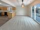 Bright dining area features a sliding glass door, modern light fixture, and opens to the kitchen at 825 Treyburn Green Dr, Indianapolis, IN 46239