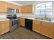 Well-lit kitchen features stainless steel appliances and light wood cabinetry at 825 Treyburn Green Dr, Indianapolis, IN 46239