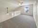 Spacious loft area with neutral carpet, ceiling fan, and natural light at 825 Treyburn Green Dr, Indianapolis, IN 46239
