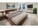Cozy main bedroom featuring a comfortable bed, modern furniture, carpet flooring, and a large window for natural light at 825 Treyburn Green Dr, Indianapolis, IN 46239
