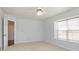 Neutral bedroom with carpeted floors, ceiling fan, and a bright window at 8417 Southern Springs Way, Indianapolis, IN 46237