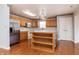 Well-lit kitchen featuring wood cabinets, stainless steel appliances, and a large island at 8417 Southern Springs Way, Indianapolis, IN 46237