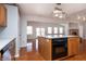 Open-concept kitchen features a dishwasher and leads to a light-filled living area at 8417 Southern Springs Way, Indianapolis, IN 46237