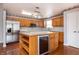 Updated kitchen featuring an island, stainless appliances, and wood cabinets at 8417 Southern Springs Way, Indianapolis, IN 46237