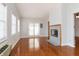 Inviting living room with hardwood floors, bright windows, and a tiled fireplace at 8417 Southern Springs Way, Indianapolis, IN 46237