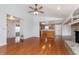 Open concept living room with fireplace, laminate flooring, and seamless flow into the kitchen at 8417 Southern Springs Way, Indianapolis, IN 46237