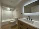 Bathroom features a white tiled shower and a light wood vanity at 1011 W 28Th St, Indianapolis, IN 46208