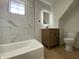Renovated bathroom featuring a tub and wood vanity at 1011 W 28Th St, Indianapolis, IN 46208