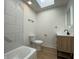 Bathroom featuring a tub, modern vanity, and illuminated mirror at 1011 W 28Th St, Indianapolis, IN 46208
