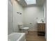 Bright bathroom featuring a vanity, tile, and a skylight at 1011 W 28Th St, Indianapolis, IN 46208