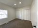 A carpeted bedroom featuring bright natural light and double closets at 1011 W 28Th St, Indianapolis, IN 46208