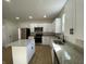 Kitchen featuring granite counters, stainless steel appliances, island, and wood floors at 1011 W 28Th St, Indianapolis, IN 46208