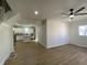 Open-concept living space with hardwood floors, fan and kitchen view at 1011 W 28Th St, Indianapolis, IN 46208