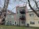 Exterior of gray townhome featuring two rear balconies and access to green space at 1014 Jackson St, Columbus, IN 47201