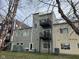 Exterior of gray townhome featuring two rear balconies and access to green space at 1014 Jackson St, Columbus, IN 47201