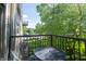 Cozy balcony featuring a metal table and chairs, offering a relaxing outdoor space with views of the surrounding greenery at 1014 Jackson St, Columbus, IN 47201