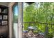 Balcony view showcasing an outdoor table and chairs overlooking the surrounding lush greenery at 1014 Jackson St, Columbus, IN 47201