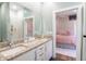 Bathroom with double sinks and granite countertops, adjacent to a bedroom at 1014 Jackson St, Columbus, IN 47201