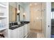 Bathroom boasts a granite double vanity, glass enclosed shower, and sleek lighting fixtures at 1014 Jackson St, Columbus, IN 47201