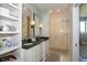 Spacious bathroom boasts double granite vanity, glass enclosed shower, and a large linen closet at 1014 Jackson St, Columbus, IN 47201