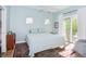 Bright blue bedroom with a walkout patio at 1014 Jackson St, Columbus, IN 47201