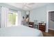 Bright bedroom with a chair, desk, and walkout balcony at 1014 Jackson St, Columbus, IN 47201