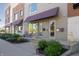 Close-up of townhome entrances with awnings, landscaping, and sidewalk seating at 1014 Jackson St, Columbus, IN 47201