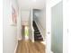 Hallway with wood floors and view of staircase and living room area at 1014 Jackson St, Columbus, IN 47201