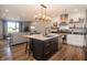 Open concept kitchen with an island, stainless steel appliances, and a seamless transition to the living room area at 1014 Jackson St, Columbus, IN 47201
