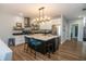 Modern kitchen boasts an island with seating, sleek appliances, open shelving, and stylish fixtures at 1014 Jackson St, Columbus, IN 47201