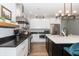 Modern kitchen with stainless steel appliances, white cabinets, and a black island at 1014 Jackson St, Columbus, IN 47201