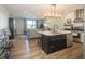 Open kitchen featuring a large island, modern lighting, and views into the living room at 1014 Jackson St, Columbus, IN 47201