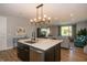 Bright kitchen with a central island, stainless steel appliances, and a view of the adjacent living room space at 1014 Jackson St, Columbus, IN 47201
