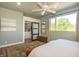 Main bedroom with large window, ceiling fan, bedside tables and ensuite access to a closet at 1014 Jackson St, Columbus, IN 47201