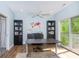 The home office features a modern desk, wooden floor, bookshelves, and a large sliding door to the balcony at 1014 Jackson St, Columbus, IN 47201