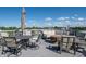 Inviting rooftop patio area with ample seating, table, umbrella, and views of the neighborhood at 1014 Jackson St, Columbus, IN 47201